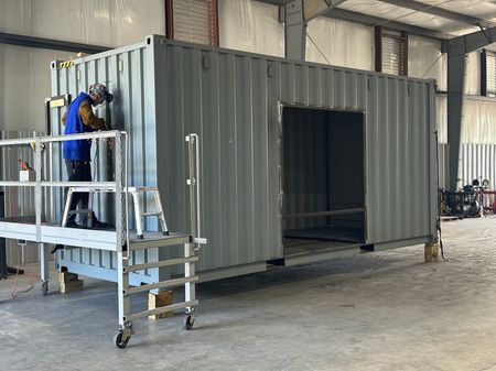 Rebox Solutions custom fabricating steel door and window bunks for a new container.