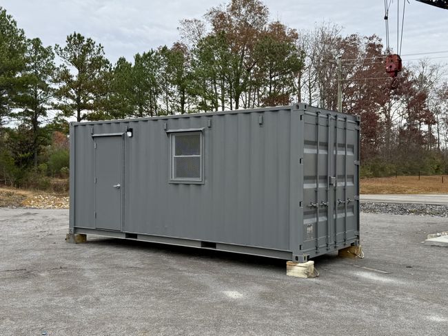 20’ mobile office space built by Rebox Solutions showing an exterior door and window, A/C unit, and 200 amp electrical panel.