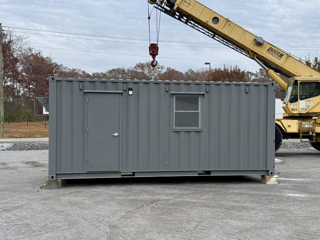 20’ mobile office space built by Rebox Solutions showing an exterior door and window, A/C unit, and 200 amp electrical panel.
